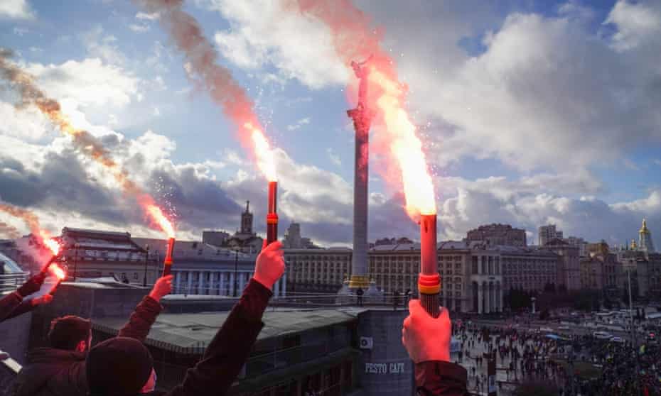 People hold flares in Maidan Square, central Kyiv, during the ‘unity march’ against Russian aggression.