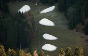 Bavaria, Germany. Artificial snow piles produced by snow cannons on a ski slope on the Tegelberg mountain