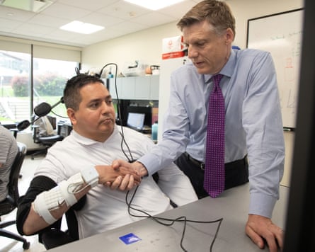 Keith Thomas (left) demonstrates his arm and hand movement with Prof Chad Bouton of the Feinstein Institutes for Medical Research.