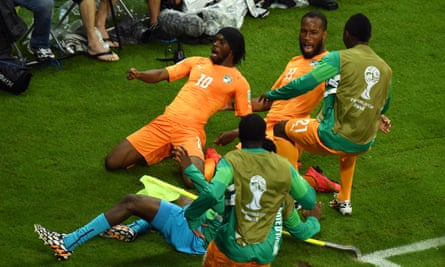 Gervinho enjoys the moment with Didier Drogba and others after scoring for Ivory Coast against Japan at the 2014 World Cup.