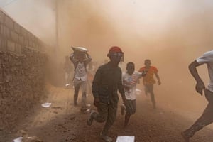 People flee the scene of a looted warehouse belonging to the peacekeeping mission in the Democratic Republic of Congo