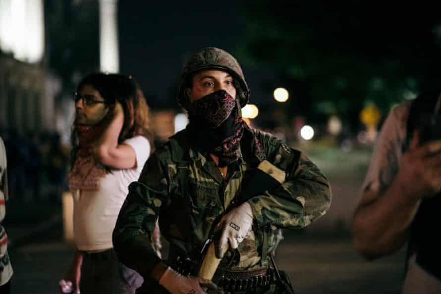 A so-called militia man shows up on the protester side and offers armed escorts to a safe position in Kenosha, Wisconsin in August.