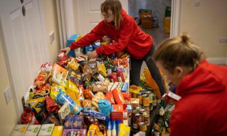 Staff organise donations for vulnerable families at a food bank.