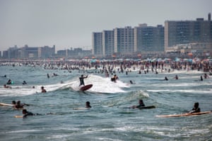 Surfers and swimmers at Rockaway Beach