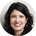 Woman with long dark hair and hoop earrings smiling