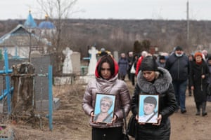 Mourners at the funeral of teachers Yelena Kudrin and Yelena Ivanova, who were killed in a shelling attack on Gorlovka.