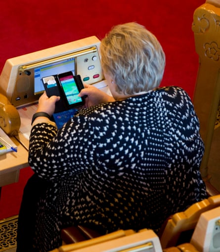 Erna Solberg, the prime minister, playing Pokémon Go in Norway’s parliament.