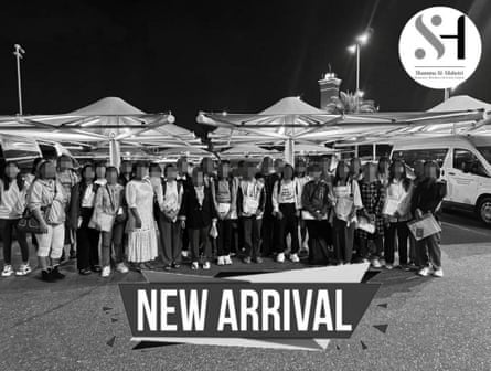 A black and white photograph of a group of people with a ‘new arrivals’ label added at the bottom