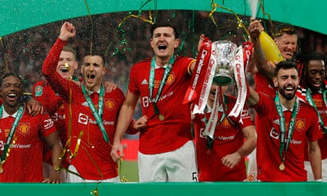 Manchester United’s club captain, Harry Maguire, lifts the Carabao Cup alongside Bruno Fernandes (right)