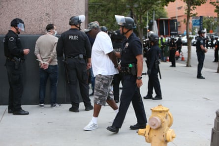 A man is taken into custody during a Black Lives Matter protest in downtown Los Angeles on 2 June 2020.