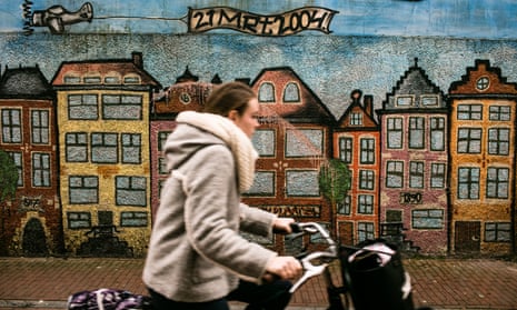 A cyclist passes a painted wall in Leeuwarden city centre