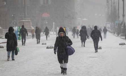 People walk through snow in central Kyiv, Ukraine, on Wednesday.