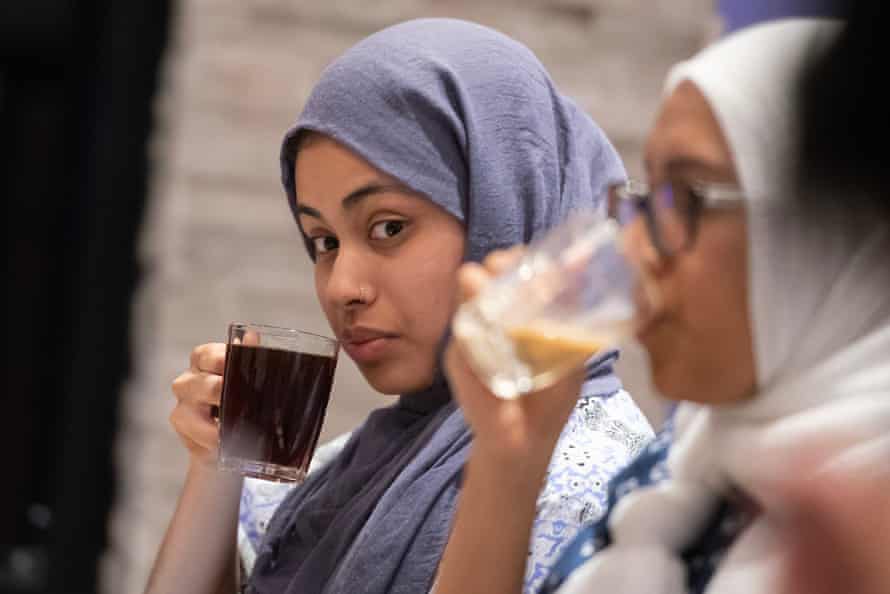 Amina Ahmad, 21, enjoys tea with friends after breaking fast at sundown in the Remas Restaurant in Hamtramck.