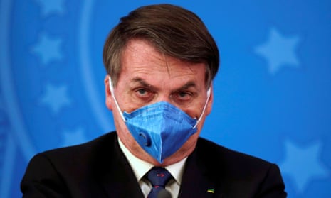Brazil’s President Jair Bolsonaro is pictured with his protective face mask at a press statement during the coronavirus disease outbreak in Brasilia.