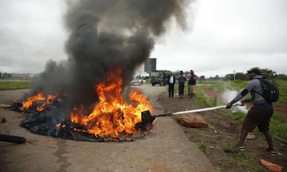 A protester burns tyres in Harare