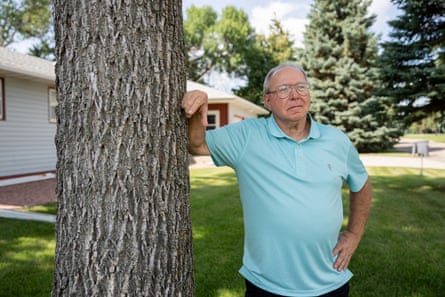 a man leans on a tree