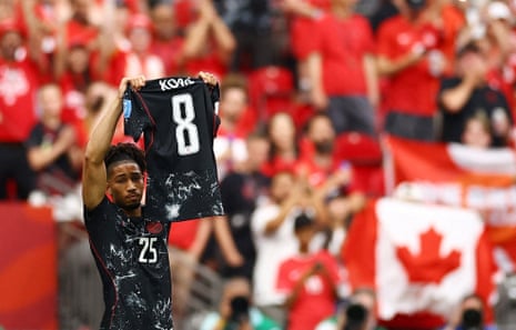 Saliba holds up the shirt of the man he replaced on the pitch, Ismael Kone.