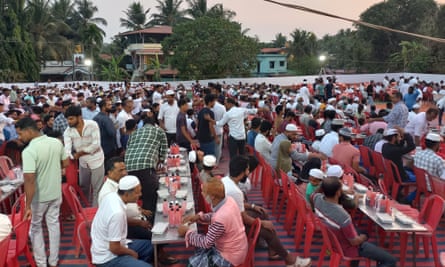 People break their fast at the iftar at Mudupu Junction near Mangalore in Karnataka state.