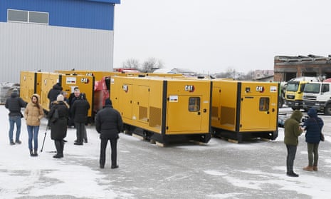 People attend a handover ceremony of 10 diesel generators provided by German government to Ukrainian food manufacturers.