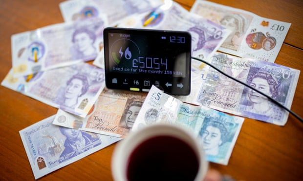 A smart energy meter pictured alongside money on a table