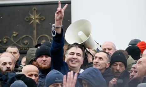 Mikheil Saakashvili flashes a victory sign after he was freed in Kiev.