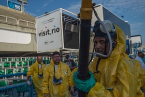 Local workers disinfect the Sambadrome in Rio de Janeiro, Brazil