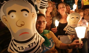 Anti-government demonstrators hold an inflatable doll in the likeness of of Brazil’s former President Luiz Inacio Lula da Silva in prison stripes, during protest outside the headquarters of the the Federal Court of Accounts in Brasilia, Brazil, Wednesday, Oct. 7, 2015.