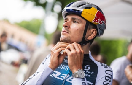 Tom Pidcock fixes his Red Bull helmet ahead of a day’s racing at the Giro d’Italia.