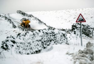 A gritter ploughs snow on a lane in Fleet Moss in the Yorkshire Dales
