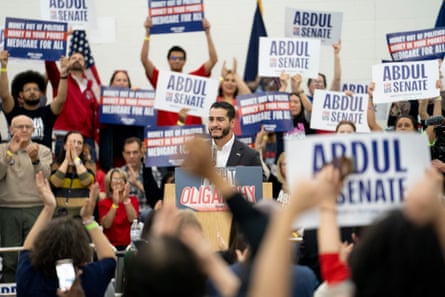 People hold up signs