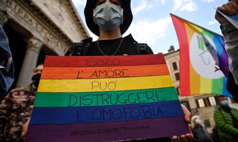 A protester in Rome carries an LGBT pride placard reading ‘only love can destroy homophobia’.