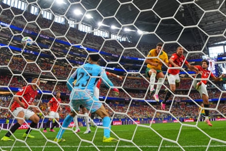 Egypt's Mohamed Hany, right, heads in an own goal.