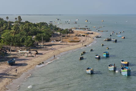 Fishing boats and fishers’ huts on the beach at Rameswaram.