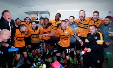 Newport County players celebrate in the dressing room after the match