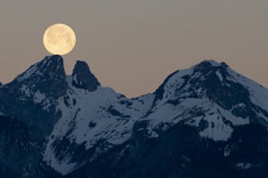 The moon sets behind the twin peaks of Les Jumelles in the Chablais Valaisan, seen from Fenalet-sur-Bex in Switzerland