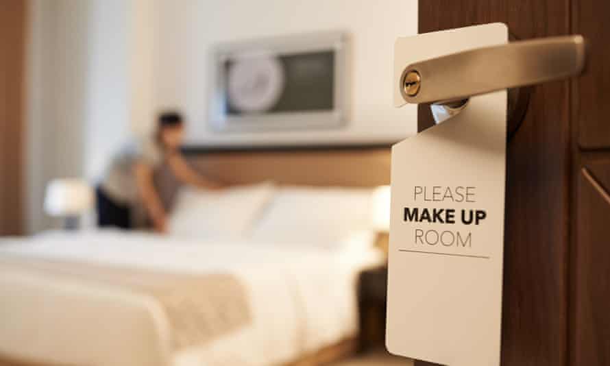 A maid cleans a hotel room