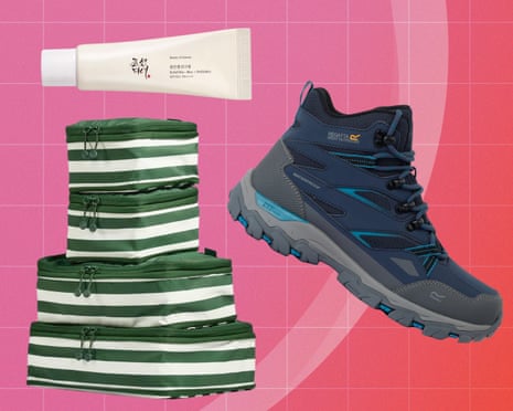 A suncream tube, striped packing cubes, and a hiking boot arranged on a pink background