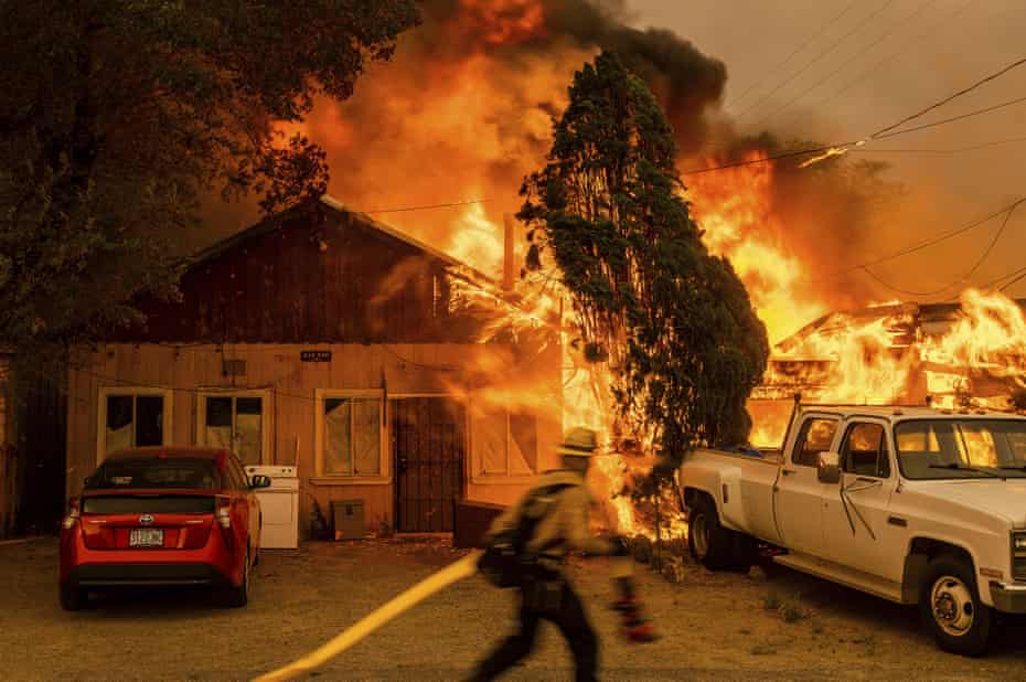Fire consumes a home as the Sugar fire, part of the Beckwourth complex fire.