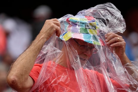 A Netherlands fan puts on rain gear before Thursday’s match.