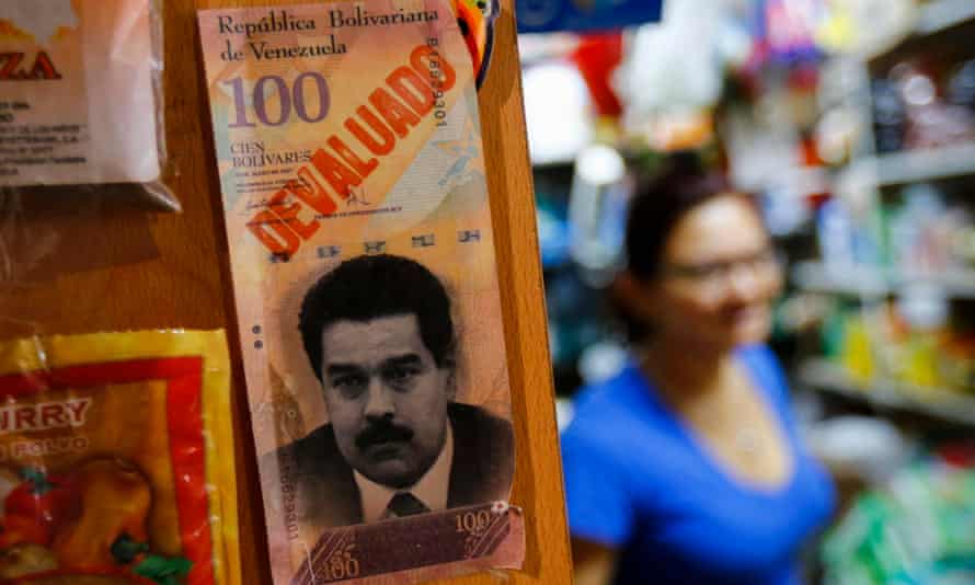A sample bank note with the face of President Nicolas Maduro and the word 'devaluated'