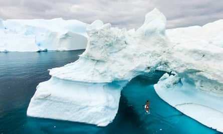 Cool head: Guirec navigating icebergs on a paddleboard.
