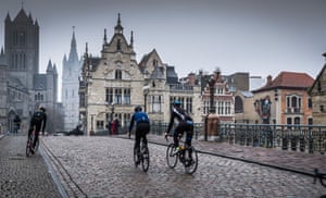 Wiggins, on the left, cycling through Ghent, the city he was born in