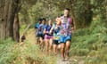 Runners in colourful clothing in bushland