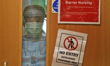 A nurse looks out from a restricted zone at a care home in April 2020