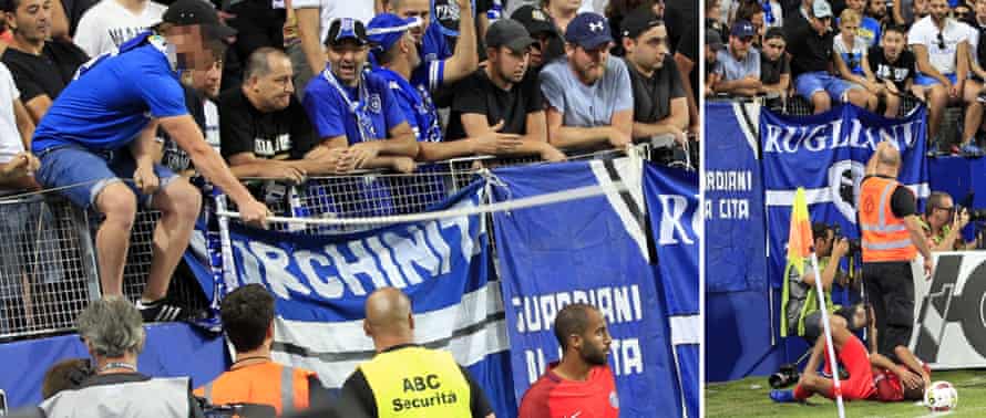 A Bastia fan strikes PSG player Lucas Moura with a stick in 2016.