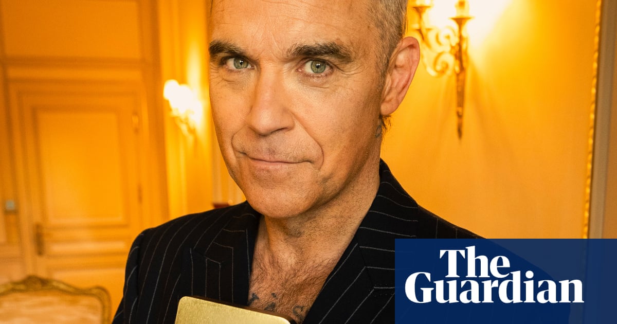 Robbie Williams breaks the Beatles’ record for UK No 1 albums, with 16th chart-topper