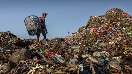 Garbage picker sits on top of Indonesia's Garbage Mountain