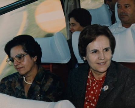 The two women sitting in a coach. They are smartly dressed.