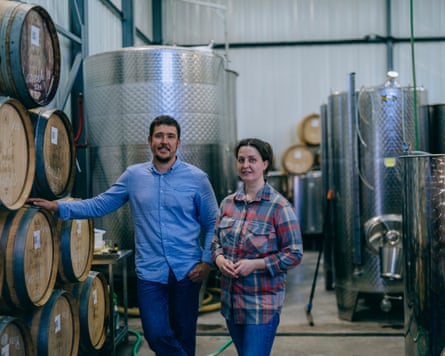 Olha Romashko, who runs the operation of Beykush winery, and her deputy, Oleksandr Pashkovsky stand next barrels of wine and machines