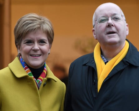 Nicola Sturgeon and Peter Murrell standing side by side and smiling